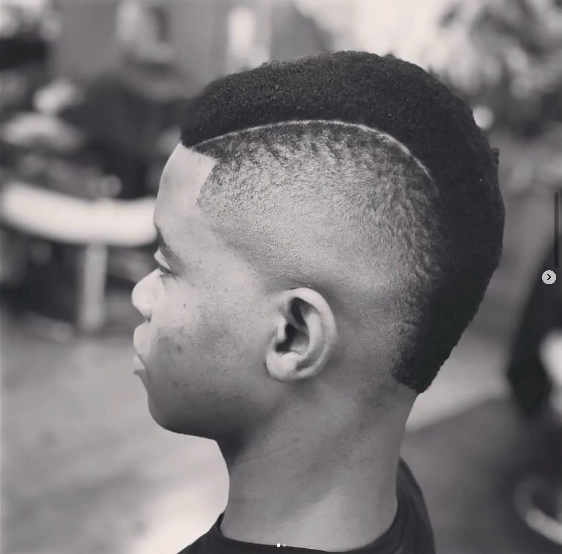 High skin fade with a curved razor part and clean lineup
